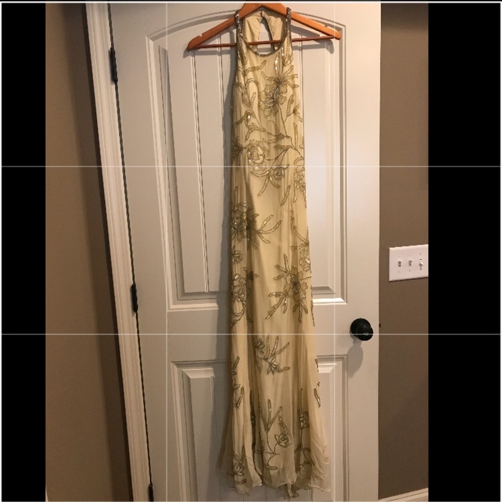 Light yellow beaded Cache formal gown.